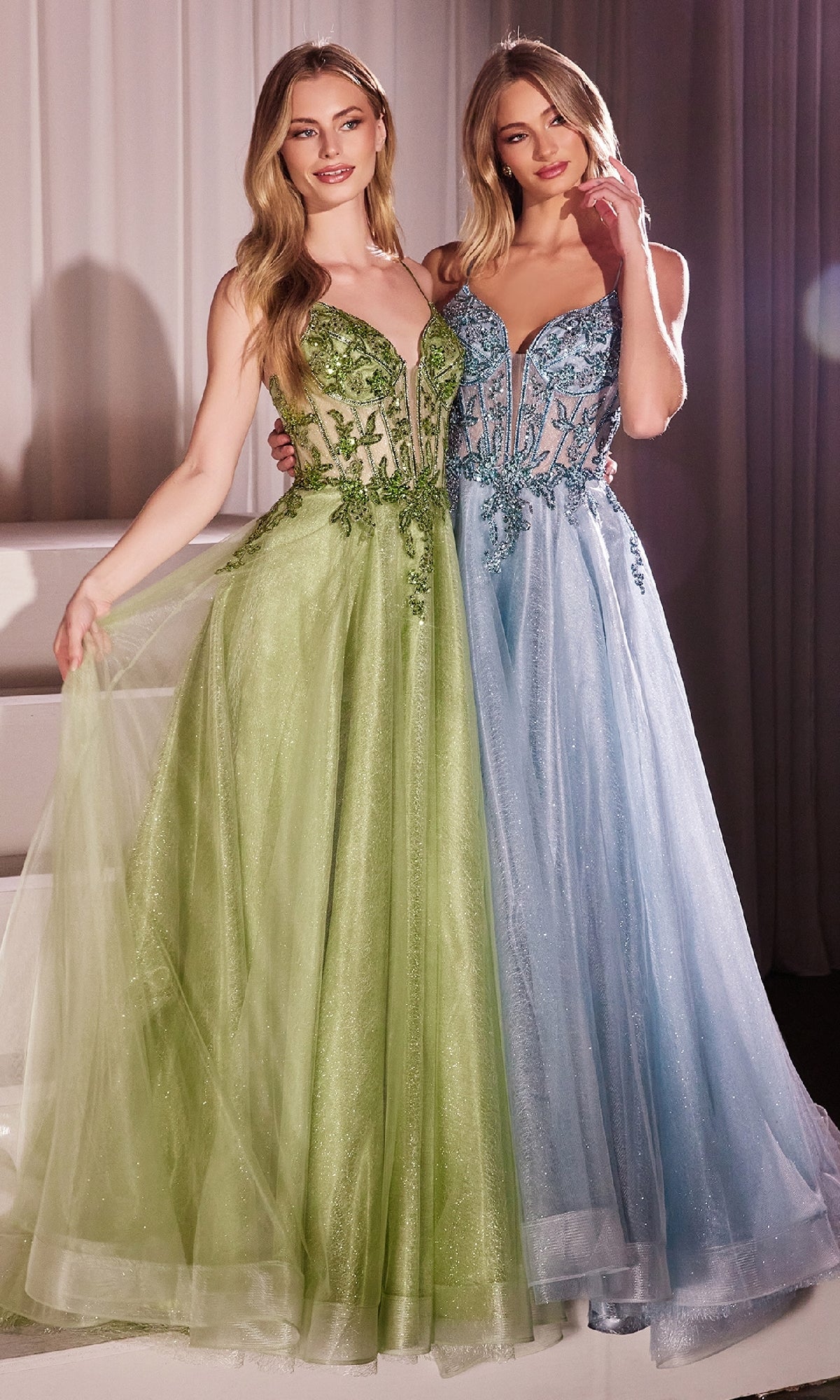Two women stand side by side in Sheer-Corset Long Prom Dress: Ladivine CC0881—one in light green, the other in pale blue. Both dresses feature elegant A-line silhouettes, sheer bodices, and delicate beaded embroidery.